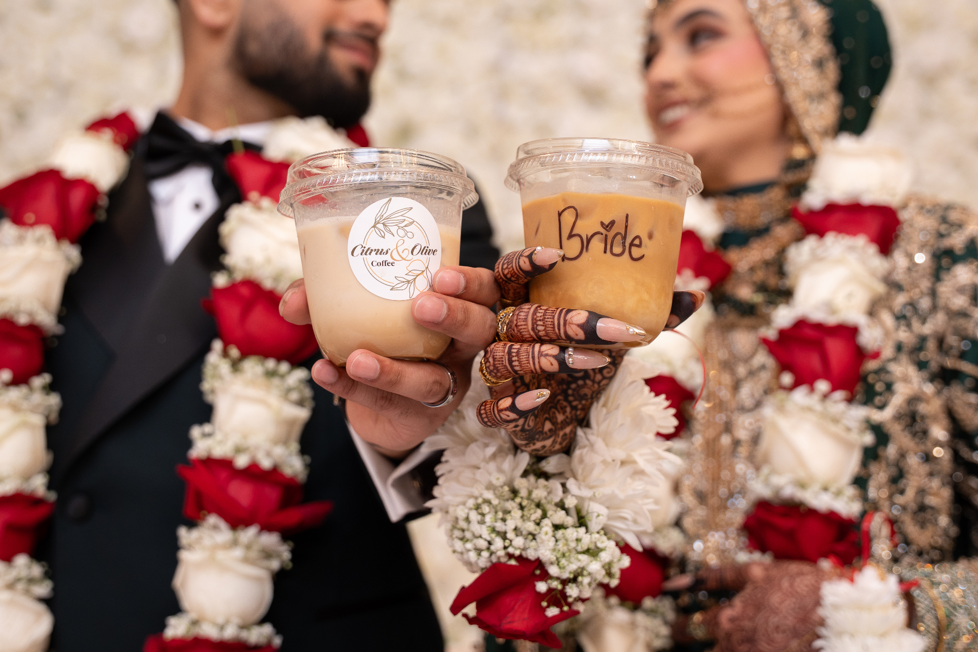Couple toasting with Citrus & Olive cups at a wedding celebration
