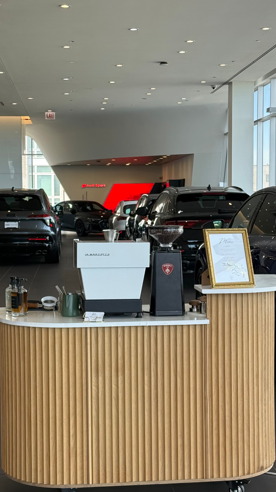 Citrus & Olive Flutes cart in fluted oak with a white top, set up with a La Marzocco espresso machine and Eureka grinder at an Audi showroom activation